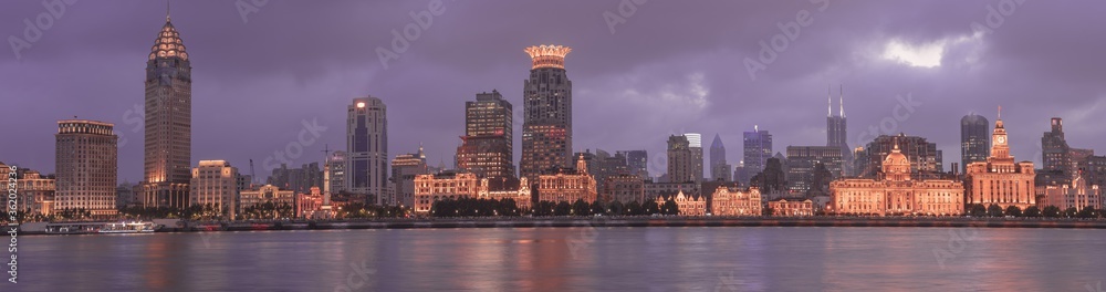 Night panorama view of Shanghai's bund, the historic and modern building skyline along the Huangpu River, China.