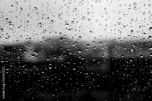 gray wet background   raindrops to overlay on the window  weather  background drops of water rain on the glass transparent