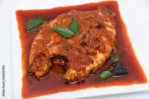 Telapia Karimeen Mulaku Curry is a hot and spicy fish curry seafood cuisine of  Alappuzha Kerala cooked with coconut milk. Popular dish in coastal area of Sri Lanka and India photo