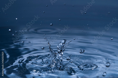 Splashing water drops causing wavy water surface