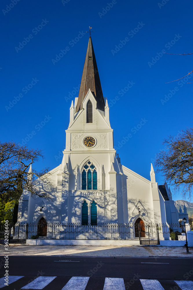 Fototapeta premium Church Moederkerk (means Mother Church) - Dutch Reformed church in Stellenbosch. This impressive building with a Neo Gothic Tower completed in 1863. Stellenbosch - town in 50 km east of Cape Town.
