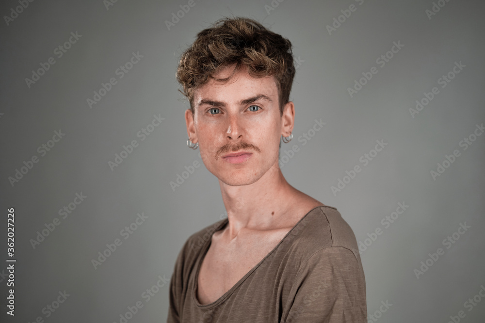 Selective focus portrait of a young blond man with blue eyes and mustache Selective focus portrait of a young blond man with blue eyes and mustache
