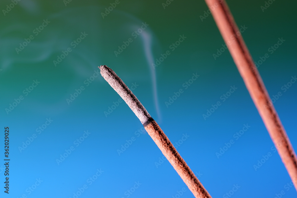 Multi colored smoke from an incense stick with color foils Photographed in front of the flash in the studio Multi colored smoke from an incense stick with color foils Photographed in front of the flash in the studio
