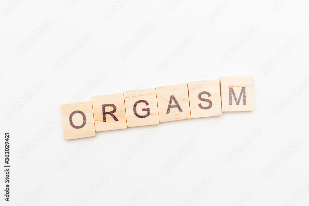 Inscription orgasm made of letters on wooden blocks. Sex education concept Inscription orgasm made of letters on wooden blocks. Sex education concept
