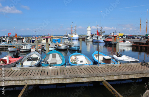 View of the picturesque Aarosund harbour (Lystbadehavn) near Haderslev in Denmark. Fishing boats on a sunny summer's day. photo