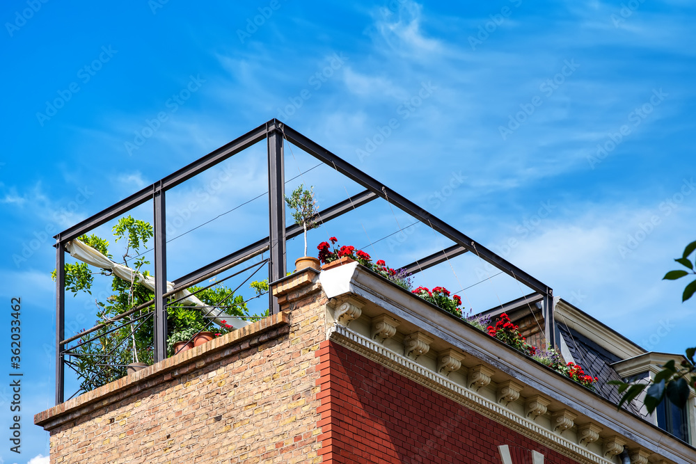 View from below on a outdoor terrace on the roof with plants and flowers View from below on a outdoor terrace on the roof with plants and flowers