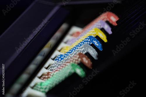 Casino chips stacked on a table, sorted by color