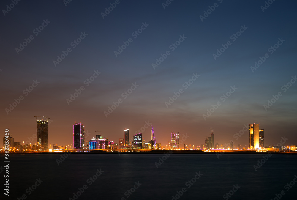 Beatiful illuminated Bahrain skyline with dramatic cloud in the evening