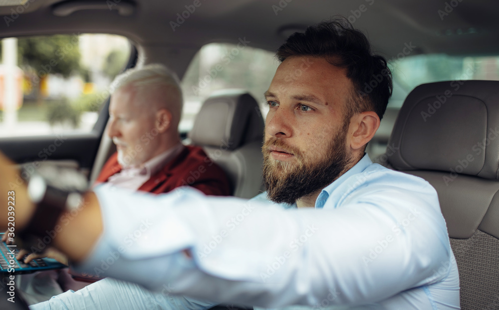 Young businessman driving car. Two businessman going on a business trip. Young businessman driving car. Two businessman going on a business trip.