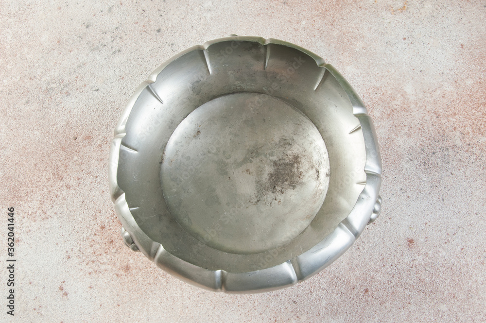 Antique metal vase on a concrete background. Antique metal vase on a concrete background.