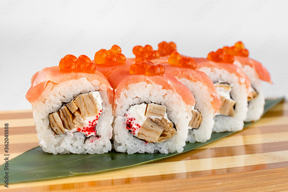 Maki Sushi Rolls set on wooden bamboo board. Japanese traditional Cuisine. White background. Maki Sushi Rolls set on wooden bamboo board. Japanese traditional Cuisine. White background.