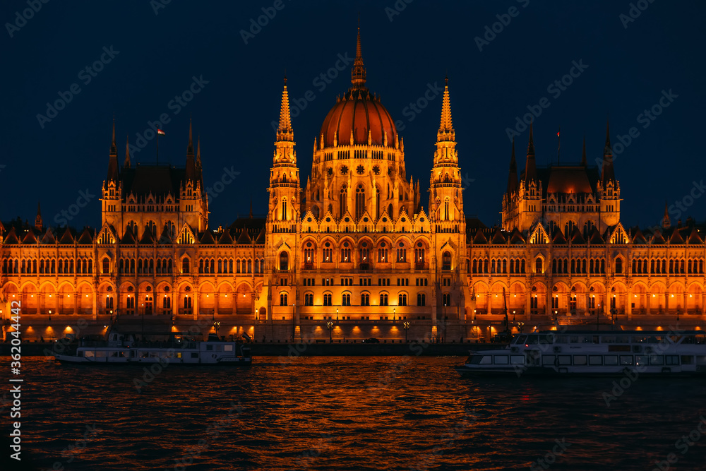 ships on the river in front of the parliament at night Budapest,