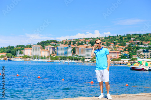 Man in blue polo on resort on summer day © Ivan