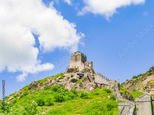 Fragment of the Great Wall of China on a background of blue cloudless sky © Sergey
