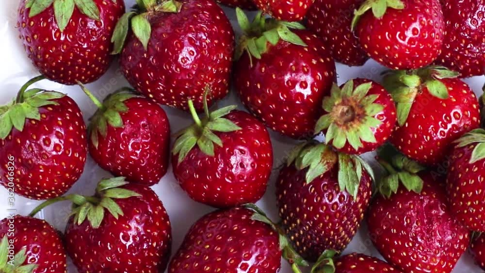 Red ripe strawberry in the white bowl on white background. Top view Red ripe strawberry in the white bowl on white background. Top view