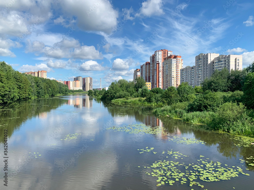 Russia, Moscow region, the city of Balashikha. Pekhorka river in summer sunny day and  view of Zarechnaya street