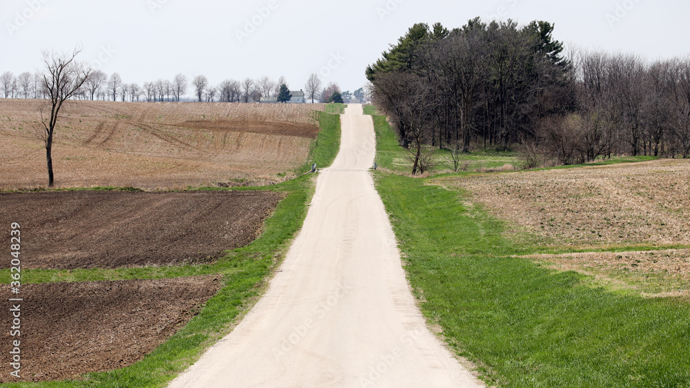 Gravel road thru rural landscape