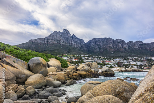 Wonderful Camps Bay nature (Kampsbaai) before sunset - affluent suburb of Cape Town. Camps Bay bordered by spectacular Twelve Apostles Mountain and glittering Atlantic Ocean. Camps Bay, South Africa.