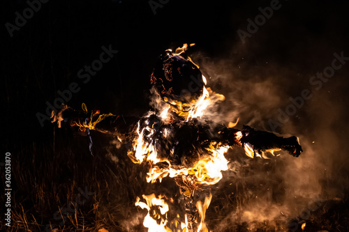 Fotografie Burning traditional scarecrow at dark night