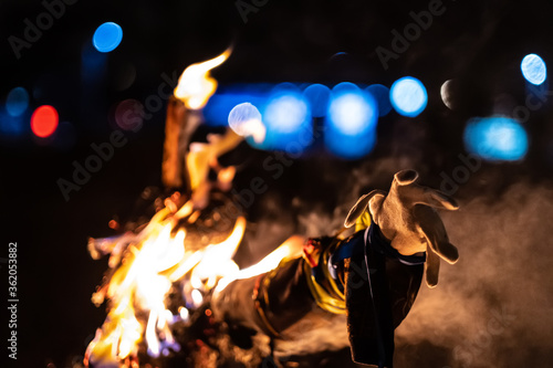 Scarecrow enveloped in flames, left hand close up