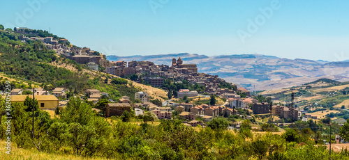 Fields and the hilltop village of Petralia Soprana in the Madonie Mountains, Sicily during summer photo