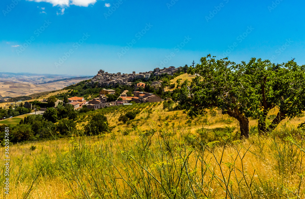 The hilltop village of Petralia Soprana against the backdrop of the Madonie Mountains, Sicily during summer