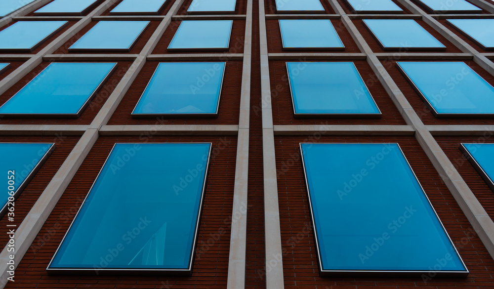 Glass windows with the sky reflection on London office building. Glass windows with the sky reflection on London office building.