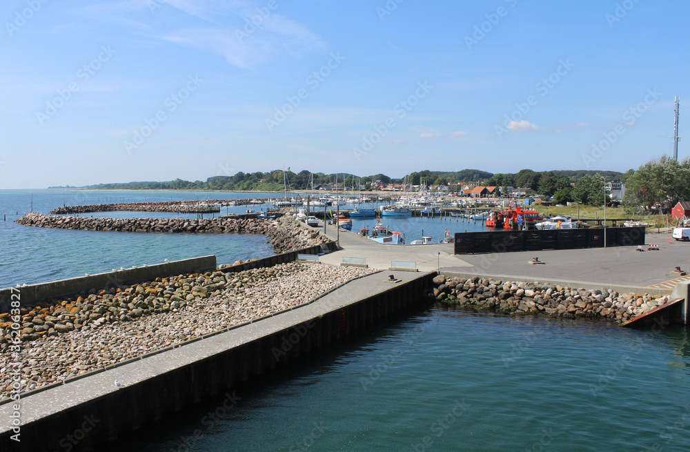 Summer view of the quaint harbour of Spodsbjerg on Langeland from the Lolland ferry. Spodsbjerg is a popular coastal holiday resort in Denmark.