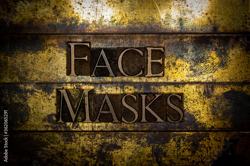 Face Masks text formed with real authentic typeset letters on vintage textured silver grunge copper and gold background