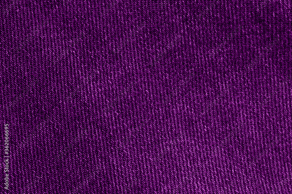 The texture of the purple fabric. The texture of purple jeans. The texture of the purple fabric. The texture of purple jeans.