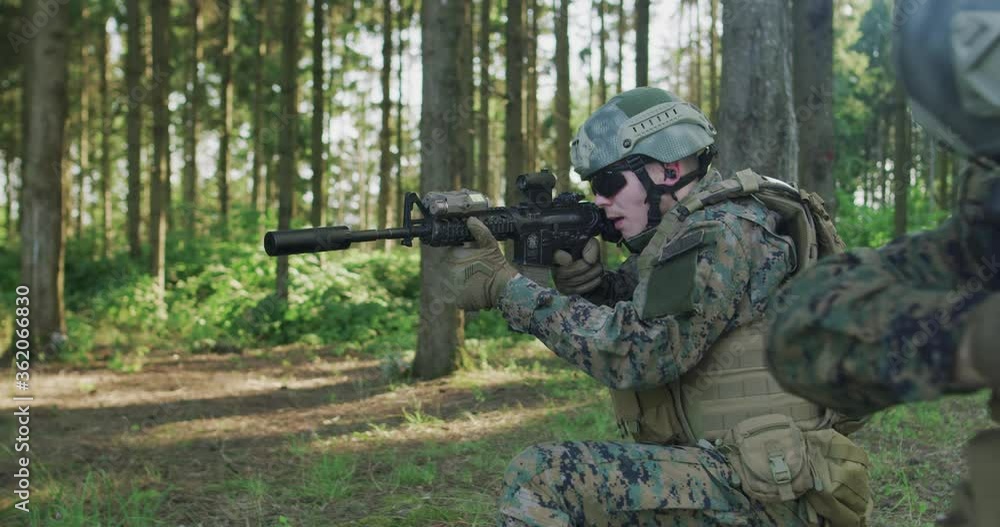 Soldiers aiming assault rifle and protecting military base Stock ビデオ ...