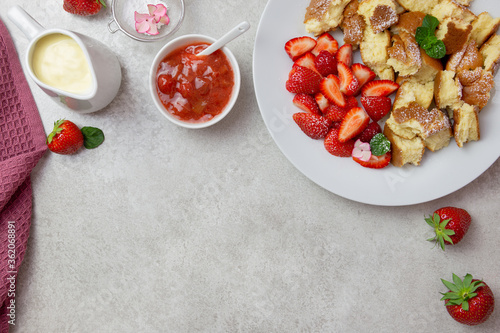 Kaiserschmarren or Kaiserschmarrn, traditional Austrian or German sweet pancake dessert, with berry, strawberry jam or rote grutze and vanilla pudding sauce. Top view. Copy space. photo