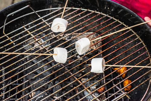 Marshmallows being heated on a grill