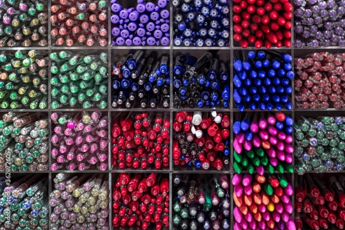 Different color pens in a stationary shop. Office supplies.