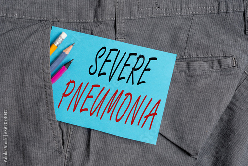 Handwriting text Severe Pneumonia. Conceptual photo acute disease that is marked by inflammation of lung tissue Writing equipment and blue note paper inside pocket of man work trousers
