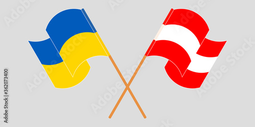Crossed and waving flags of the Ukraine and Austria