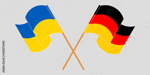 Crossed and waving flags of the Ukraine and Germany
