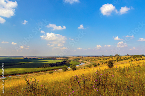 View from the hill to the river and agricultural fields to the horizon and blue sky. Russia  Krasnodar Territory.