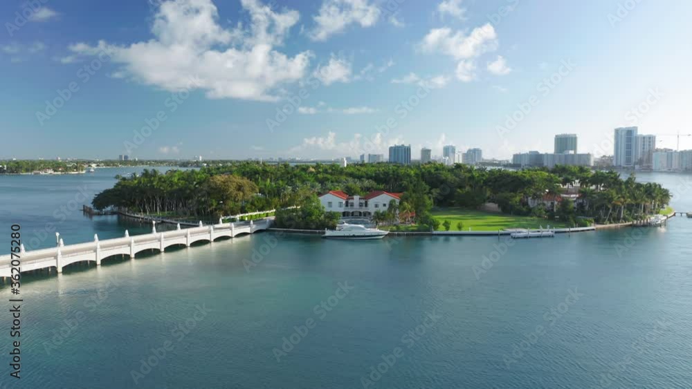 Tropical nature of island surrounded by the clear blue waters on a sunny day. 4K aerial slow motion background for tourism business. Circle view of Star Island, Miami Bay Area, Florida, USA. Tropical nature of island surrounded by the clear blue waters on a sunny day. 4K aerial slow motion background for tourism business. Circle view of Star Island, Miami Bay Area, Florida, USA.