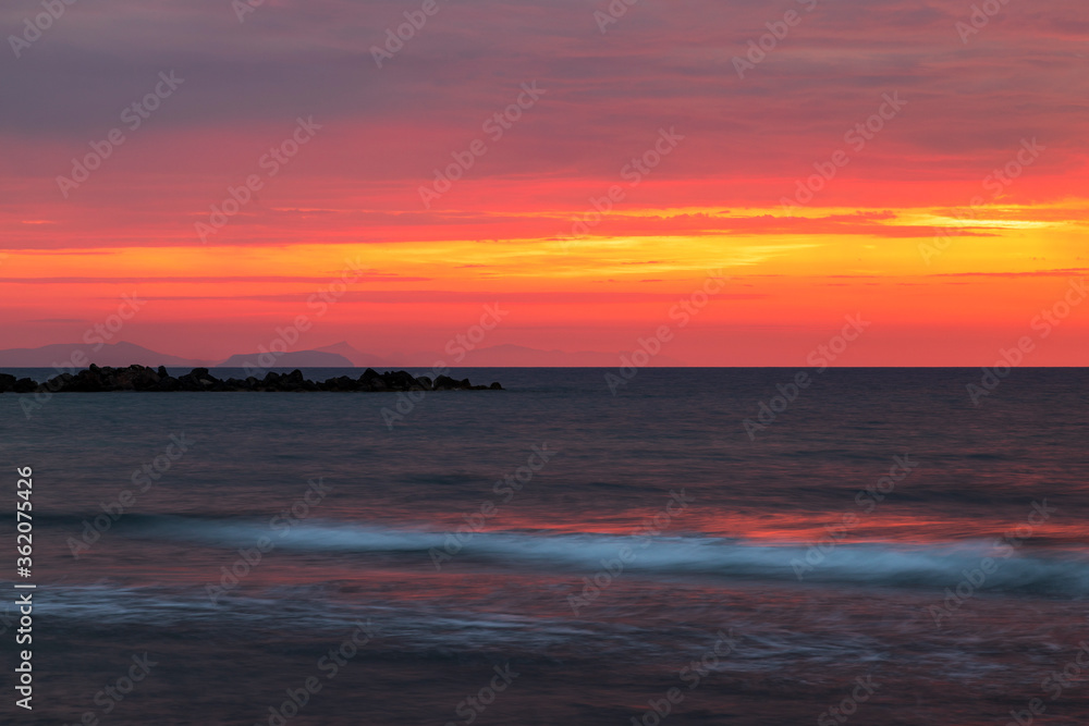 Fototapeta premium Sunrise at the beach In Monolithos on the island of Santorini in Greece.