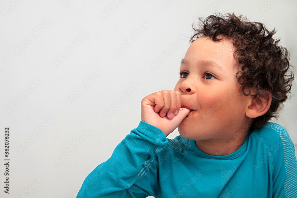 Wall Mural little boy sucking thumb on white background with people stock image stock photo