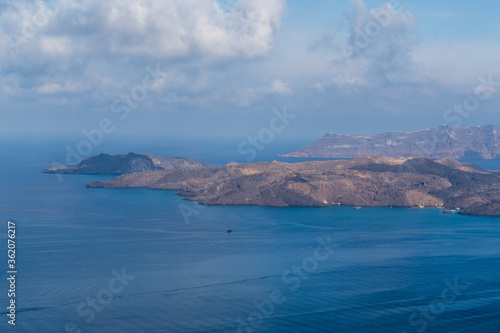 View of the sea and coast on the island of Santorini caldera in Greece. The background is a blue sky. © Roman Bjuty