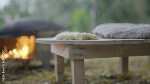 Shift forcus between dough and fire inside an oven, making traditional Lebanese bread photo