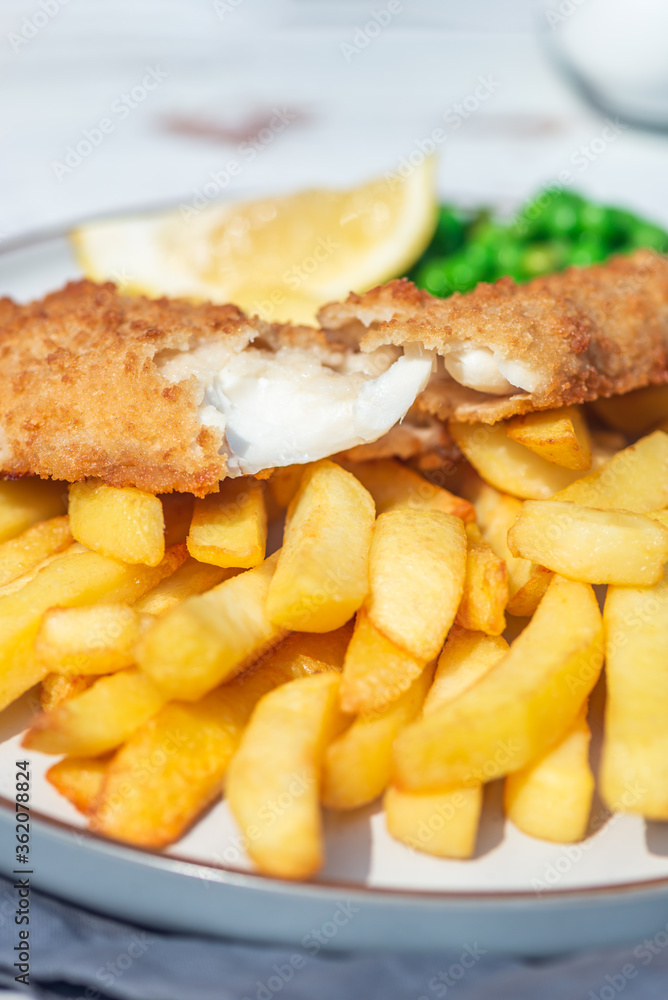 Traditional English Food such as Fish and Chips with green peas served in the Pub or Restaurant Traditional English Food such as Fish and Chips with green peas served in the Pub or Restaurant
