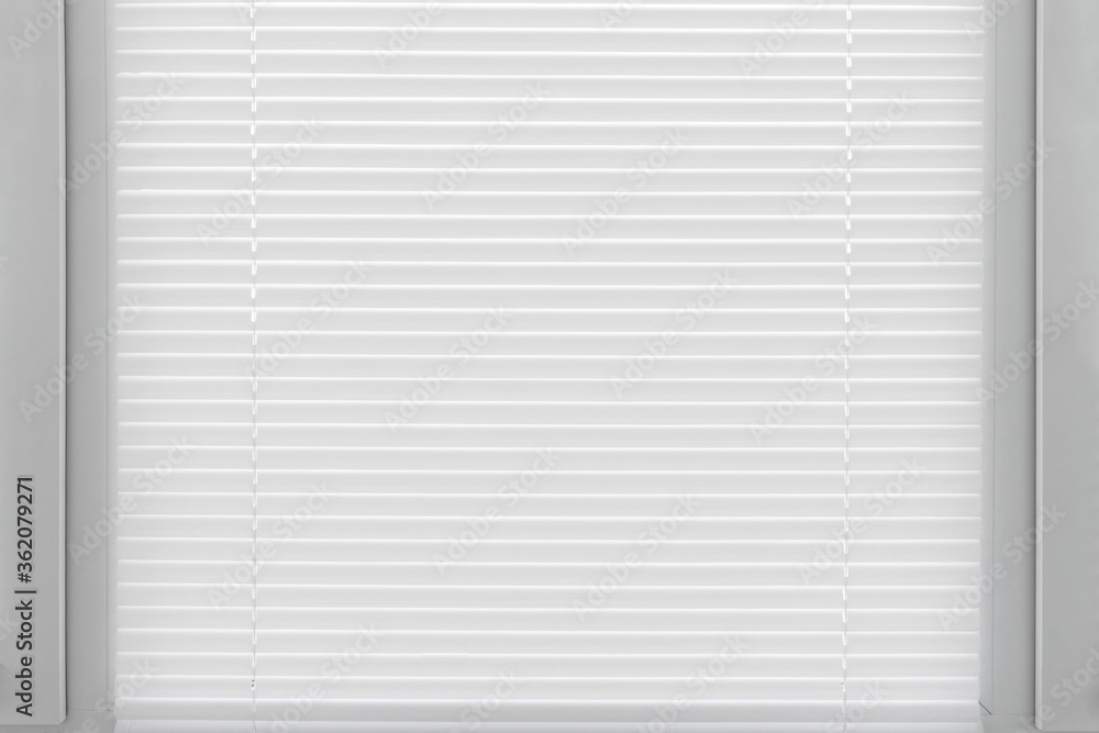 Window from the slats white venetian blinds. Decoration interior of room. Window from the slats white venetian blinds. Decoration interior of room.