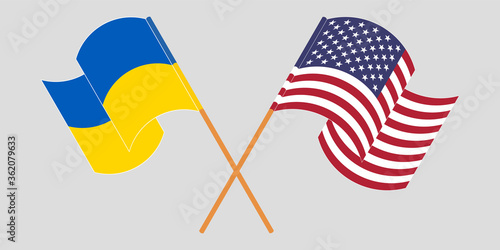 Crossed and waving flags of the Ukraine and the USA