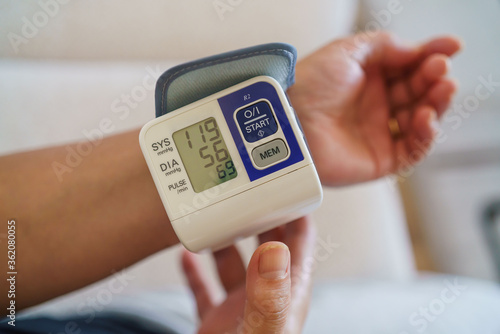 Patient measuring blood pressure. Hypertension