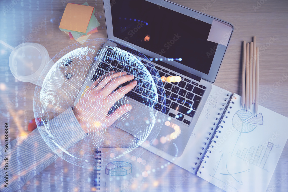 Multi exposure of man's hands typing over computer keyboard and world map hologram drawing. Top view. Technology concept. Multi exposure of man's hands typing over computer keyboard and world map hologram drawing. Top view. Technology concept.