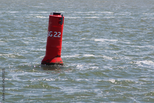 Red life buoy in the sea near Terschelling, the Netherlands.