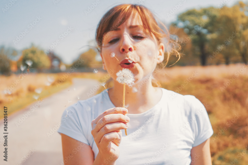 Beautiful young blonde woman with white top blowing dandelions #1 Beautiful young blonde woman with white top blowing dandelions #1
